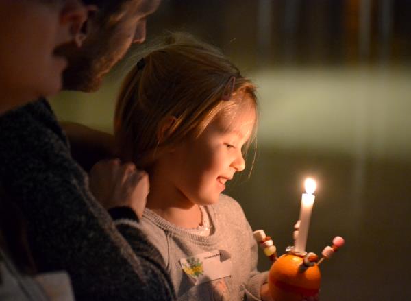 A lighted candle in a Christingle celebration