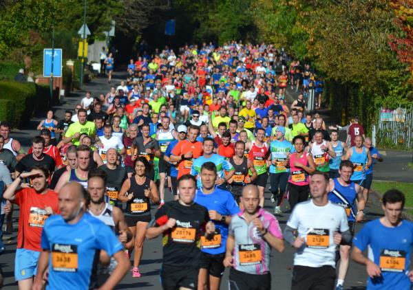 A huge crowd of runners coming down Selly Park Road