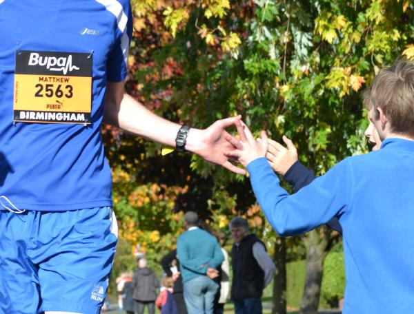 High fives for a passing runner