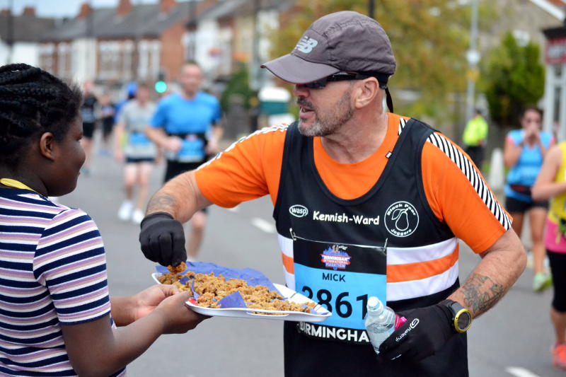 A runner takes a piece of cake