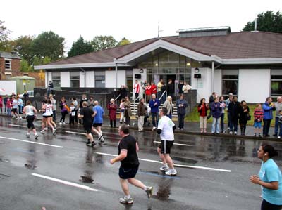 Runners head along Pershore Road past our building with
                spectators by the roadside and on the church steps