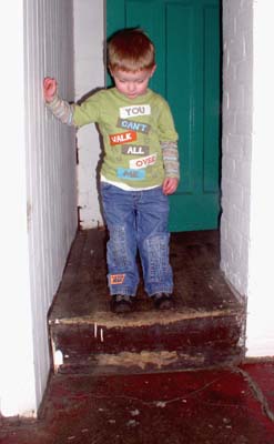 A small person looks down at a big step